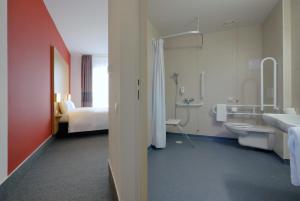 a hotel room with a bathroom with a toilet and a sink at B&B Hotel Prague City in Prague