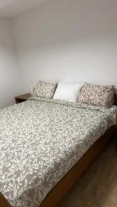 a bed with two pillows on top of it at Apartments Linic in Nin