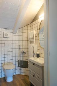 a bathroom with a toilet and a sink and a mirror at Capriccio Art Hotel in Serravalle Scrivia