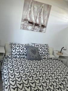 a bedroom with a bed with a black and white comforter at Apartments Linic in Nin