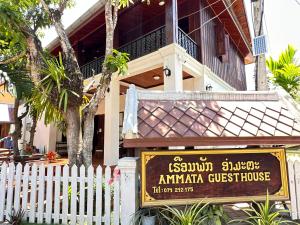 a building with a sign in front of a house at Ammata Boutique Villa in Luang Prabang