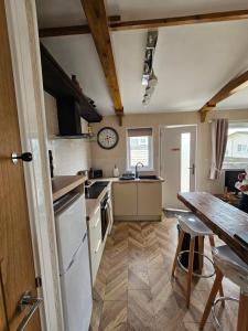 a kitchen with a table and a counter top at Beautiful & Stunning 1-Bed Chalet in Bridlington in Bridlington