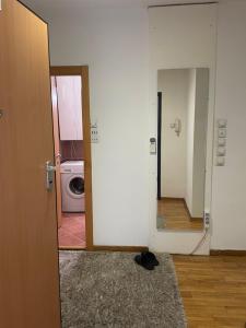 an open door to a laundry room with a washing machine at Belgrade with love in Novi Beograd