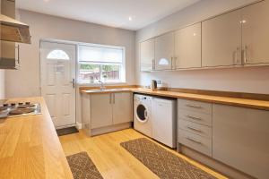 a kitchen with a washer and dryer in it at Host & Stay - Britton Hall Bungalow in Westgate