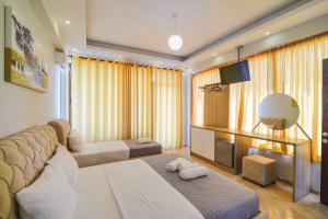 a living room with a couch and a mirror at Hotel Milo Ksamil in Ksamil