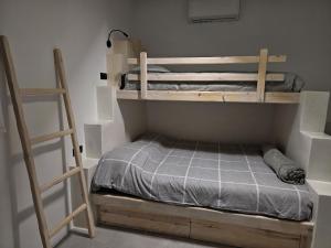 a bedroom with two bunk beds and a ladder at Metochi Olokalon, Sidonia in Psari Forada