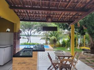 a patio with a table and chairs and a television at Rancho Santa Helena in Juazeiro +32 photos