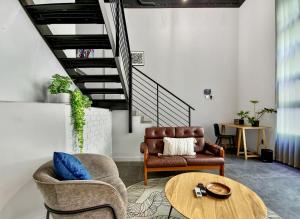 a living room with a couch and a table at BlackBrick Cape Town Foreshore in Cape Town