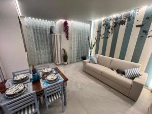 a living room with a couch and a table at beach house in Chioggia