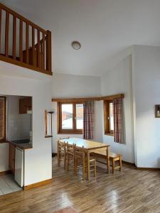 a kitchen and dining room with a table and chairs at La Tania La Saboia sleep 8 private Sauna lounge dining 2 bathrooms kitchen 2 balconies ski in out in La Tania