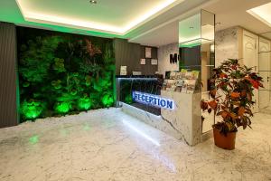 a lobby with a large aquarium in the wall at Moss Suites Hotel in Istanbul