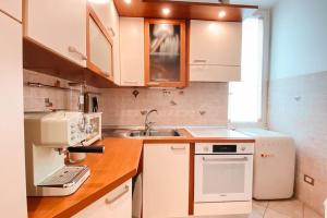 a kitchen with white appliances and a sink at Casa Di Davide in Anzio