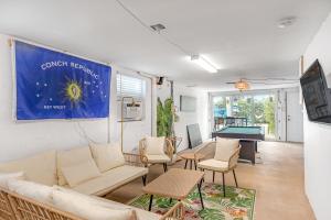 a living room with a couch and a pool table at The Salty Seahorse in Key Colony Beach