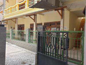 a gate in front of a building with a balcony at OYO Life 92620 Syfa Kost in Malang