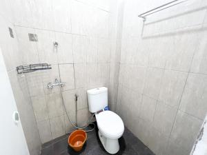 a small bathroom with a toilet and a shower at OYO Life 92630 Siliwangi Residence 63 in Bandung