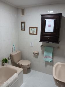 a bathroom with a toilet and a tub and a sink at Duplex Las Piraguas in Arriondas