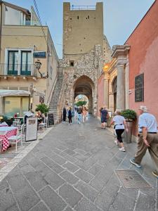 a group of people walking down a street at Luxury Berto Home in Taormina