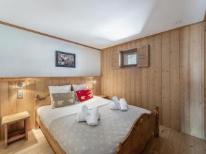 a bedroom with a bed in a room with wooden walls at Appartement Val Thorens, 4 pièces, 6 personnes - FR-1-640-11 in Val Thorens