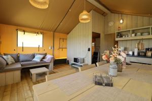 a living room with a couch and a table at Landgut Voigtsmühle in Friedland