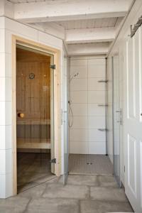 a bathroom with a shower and a tub at Blinkfüer - a88738 in Nordhorn