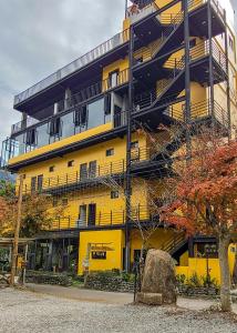 a yellow apartment building with a fire escape at 達芭凱民宿 Tabakai B&B in Xinyi