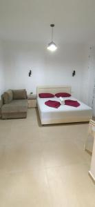 a bedroom with a bed and a couch at Nika Apartments in Ulcinj