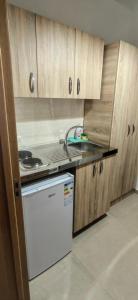 a kitchen with a stove and a white dishwasher at Nika Apartments in Ulcinj