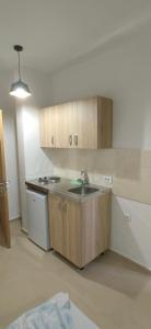 an empty kitchen with a sink and a stove at Nika Apartments in Ulcinj