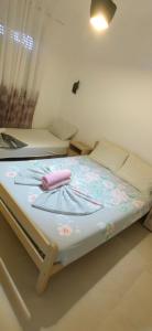 a small bedroom with a bed with flowers on it at Nika Apartments in Ulcinj