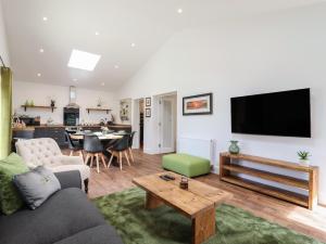 a living room with a couch and a table at The Goose Shed in Canterbury