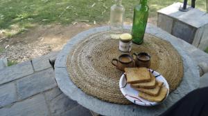a table with a plate of bread and glasses and a sandwich at H2H Bir l Nature Camps in Bīr