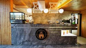 a bar in a restaurant with a laptop on a counter at Golden Night Hotel in Najran