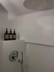 two bottles of wine sitting on a shelf in a bathroom at Rustico Leoro in Ponte Brolla