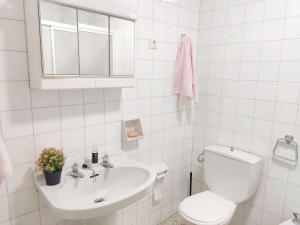 La salle de bains blanche est pourvue de toilettes et d'un lavabo. dans l'établissement Casa de Ribeira Sacra con calefacción, à Pantón