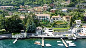 an aerial view of a city with boats in the water at Regina di Laglio - Free Parking, Garden, Lake View in Laglio