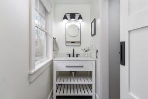 a white bathroom with a sink and a mirror at Blue Heron Bungalow 5 Min to Downtown Black Mtn in Black Mountain +30 photos