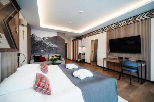 Postel nebo postele na pokoji v ubytování Rysy Boutique Hotel