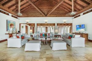 a living room with white furniture and a wooden ceiling at INGENIO 9 TOP RATED VILLA WiTH POOL GOLF CARTS STAFF in La Romana