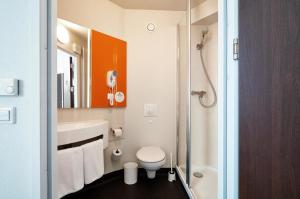 a bathroom with a toilet and a sink and a shower at B&B Hotel Warszawa-Okęcie in Warsaw