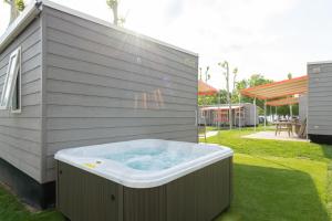 a hot tub in the side of a house at San Francesco Camping Village in Desenzano del Garda