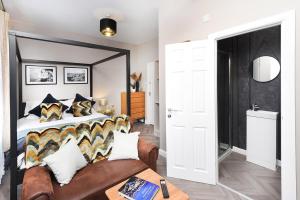 a bedroom with a large bed and a couch at Ocho Homes by Eight Continents in Belfast +25 photos