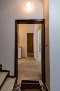 a hallway with a door leading into a room at H&G Old Town Apartment in Corfu