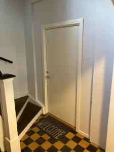 una puerta en un pasillo con suelo a cuadros en Free parking central 2bedrooms with terrace en Ålesund