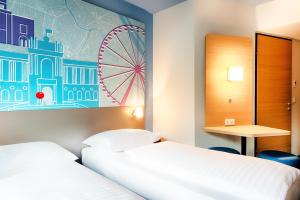 Postel nebo postele na pokoji v ubytování B&B Hotel Wien-Meidling
