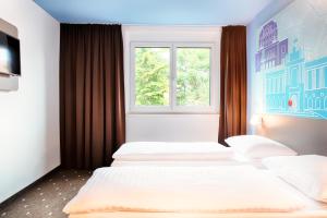 Postel nebo postele na pokoji v ubytování B&B Hotel Wien-Meidling
