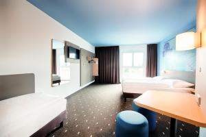 Postel nebo postele na pokoji v ubytování B&B Hotel Wien-Meidling