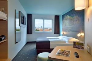 a hotel room with a bed and a window at B&B Hotel Wien-Hbf in Vienna