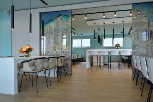 a dining room with white tables and chairs at B&B Hotel Wien-Hbf in Vienna