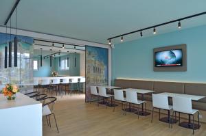 a dining room with white tables and chairs at B&B Hotel Wien-Hbf in Vienna