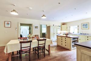 a kitchen with a table and chairs in a kitchen at The Old Rectory Lodge in Dorchester